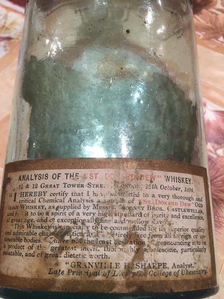 The back label of an original Donard Dew bottle, printed with Granville H. Sharpe's 1894 chemical analysis certifying the whiskey's purity and quality.