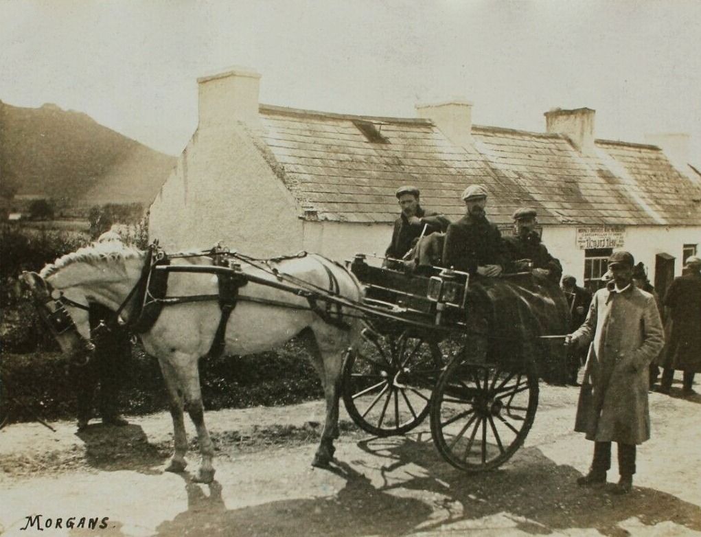 An old photograph of a country public house at Leitrim near Castlewellan, with a horse and trap outside and a sign for Mooney Bros. and Donard Dew above the door.