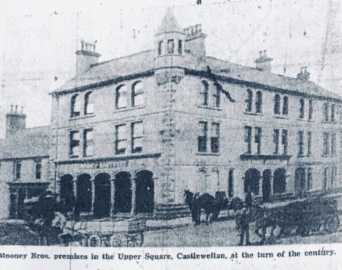 The Mooney Brothers premises in Upper Square, Castlewellan, photographed around the turn of the twentieth century, with horse-drawn carts outside.